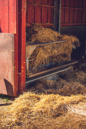Stable with golden hay in a rural environmentの写真素材