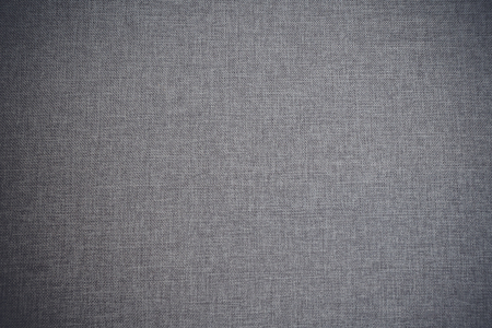 Textile background in grey color in wool fabric with classic fiber texture