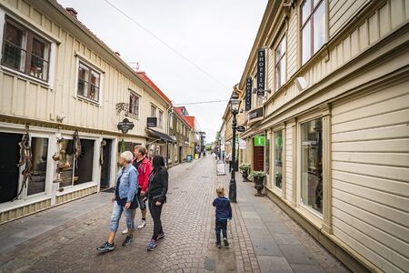 JÃ¶nkÃ¶ping, Sweden - JULY 30 - 2017: Tourists looking at windows in a shopping street in JÃ¶nkÃ¶pingのeditorial素材