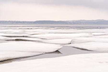 Ice floe on a frozen lake in the wintertime in Decemberの写真素材
