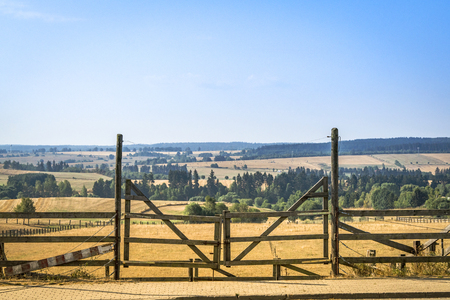 Wooden gate at a ranch in a beautiful rural landscapeの写真素材