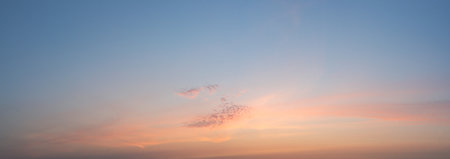 Panorama sky in pastel colors in the sunset with fluffy clouds.の写真素材
