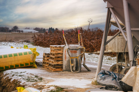 Home improvement in the winter with a wheel barrow in the sunsetの写真素材