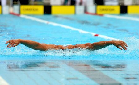 Powerful male swimmer swimming butterfly strokeの写真素材