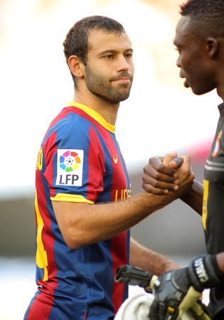 Javier Mascherano(L) of FC Barcelona shake hands with Kameni(R) before the match between against RCD Espanyol at the Nou Camp Stadium on May 8, 2011 in Barcelona, Spainのeditorial素材