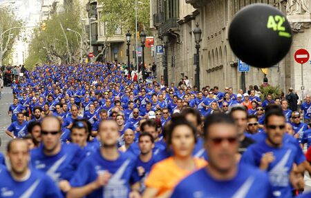Barcelona street crowded of athletes running during Bombers Race in Barcelona April 21, 2013 in Barcelona, Spainのeditorial素材
