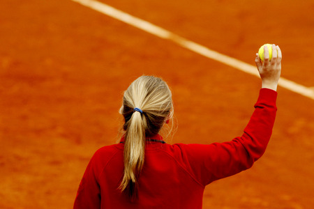 Ball girl waiting with the ball during a tennis match