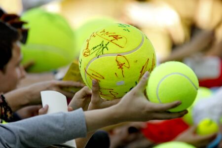 Tennis fans hold a ball asking for an autograph to the players during a Barcelona tennis tournament Conde de Godo on April 22, 2015 in Barcelona Spainのeditorial素材
