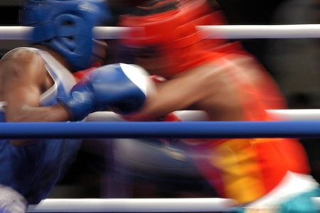 Generic boxers throwing punches during a boxing match in a ring.