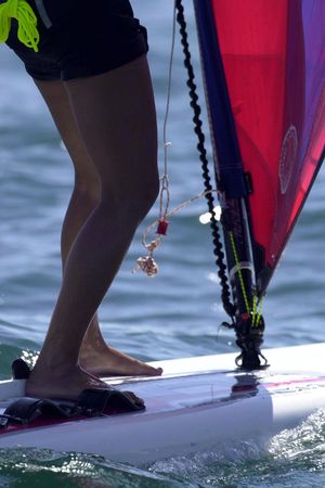 A sailboarder rides along the ocean.の写真素材