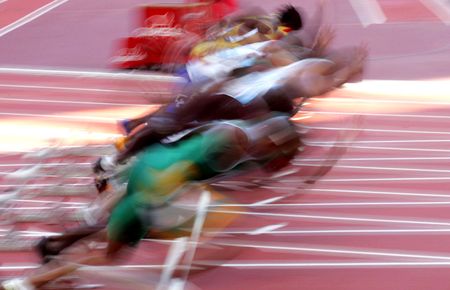 Male runners take off from the blocks at the start of the race.