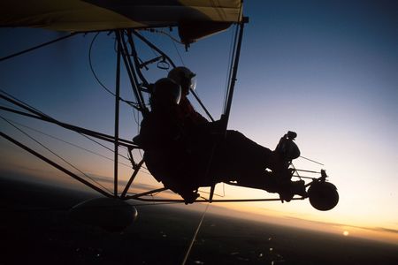 Two pilots fly in an ultralight plane.の写真素材