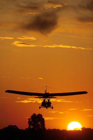 Two pilots fly in an ultralight plane.の写真素材