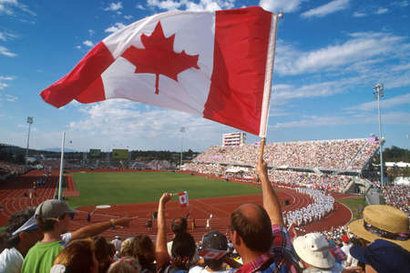 A fan waves a Canadian flag at the Commonwealth Games.の写真素材