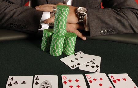 A poker player with his chips and cards.のeditorial素材