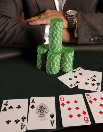 A poker player with his chips and cards.