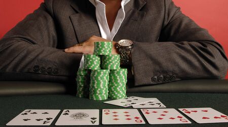 A poker player with his chips and cards.