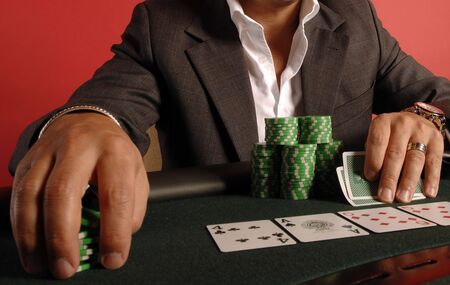 A poker player with his chips and cards.のeditorial素材