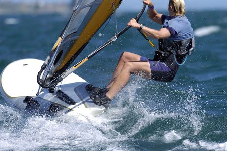A woman sails through some rough water in the bay.の写真素材