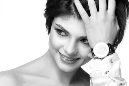 Portrait of the smiling young woman with hours on a hand.の写真素材