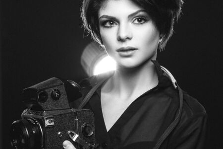 Stylish woman photographer in studio. Black and white.の写真素材