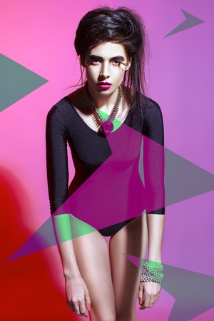 The stylish girl model on a pink-violet background. Studio shot. Design model.の写真素材