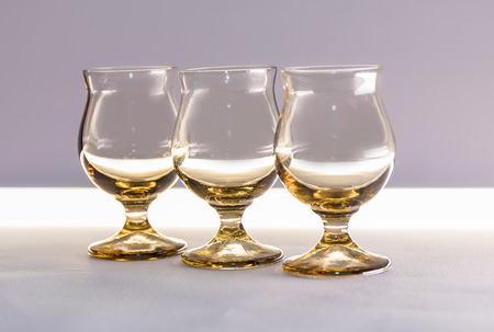 Glasses for wine and cocktails on a table on a white background.の写真素材