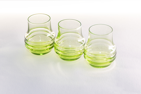 Glasses for wine and cocktails on a table on a white background.の写真素材