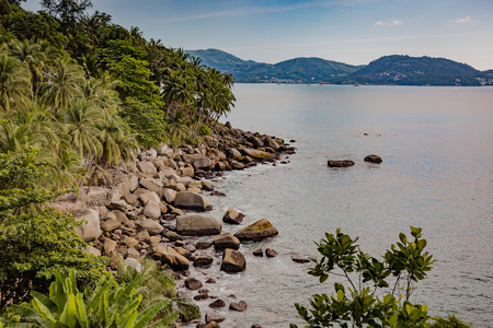 Beautiful seascape. Sea, mountains, sky, sunset and palm trees. Beautiful places of Phuket, Thailand.の写真素材