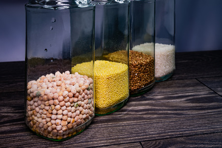 Buckwheat grain, millet, peas and rice in glass jars.の写真素材