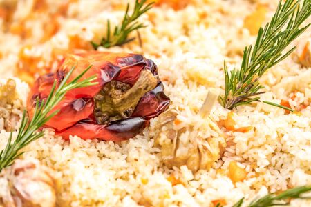 Pilaf with lamb, carrots, tomatoes, pepper, dill and garlic. Rice with meat, national Uzbek cuisine.の写真素材