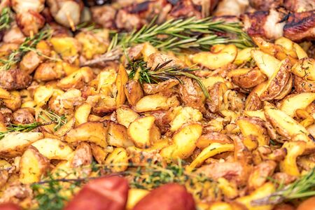 Fried potatoes with fried sausages in a pan. Dish fried potatoes with sausages, onions, garlic, cumin, pepper and seasonings.の写真素材