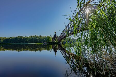 Panorama of the Vuoksa River overlooking the Church of St. Andrew the First Called on a sunny summer day. Leningrad region, Russiaの写真素材
