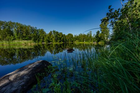 Delightful landscape of Russian nature. Clouds are reflected in the lake.の写真素材