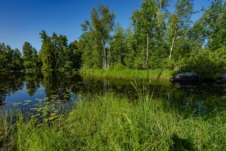 Delightful landscape of Russian nature. Clouds are reflected in the lake.の写真素材