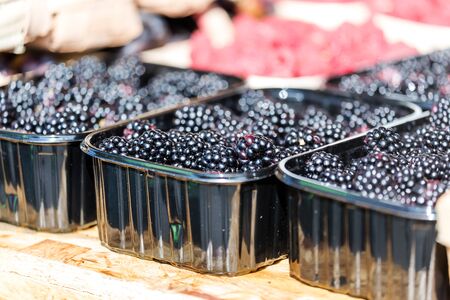 Ripe berries in trays at the vegetable market. Summer harvest.の写真素材