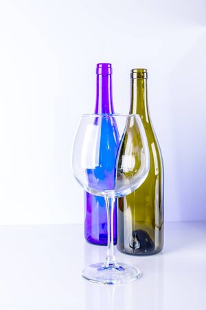 Glass bottles of different colors and different sizes on a white background.の写真素材