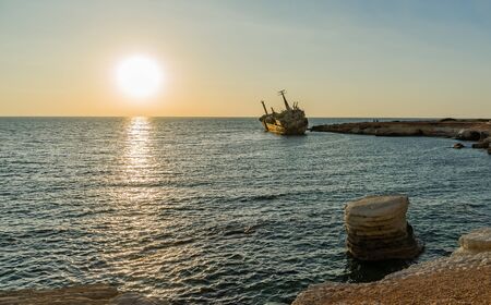 Beautiful seascape and shipwreck. Abandoned ship Edro III at sunset near the Paphos, Cyprus.の写真素材