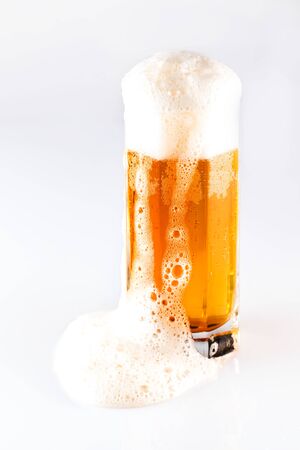 Bottle and glass of beer on a white background. Large malt cold drink. Studio photography on a white isolated background.の写真素材