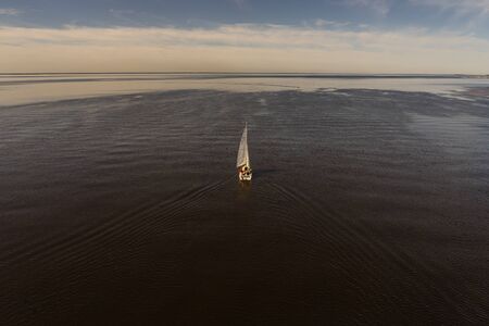 Sailing yacht in the open sea number 13. View from the top point. A sailboat sailing over the...