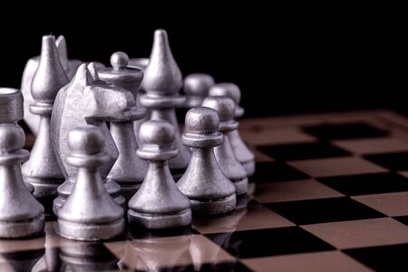 Chess pieces in silver on a black background. Board game chess.