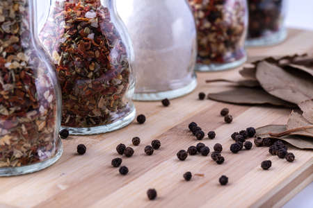 Set for cooking delicious dishes. A mixture of spices in jars. Various herbs, sea salt, hot pepper,...