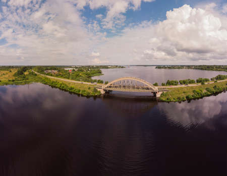 Panorama of the bridge over the Volga river in Kalyazin, Tver region, Russia. Beautiful sky, the reflection of the clouds. Photo from a drone on a Sunny day.の写真素材