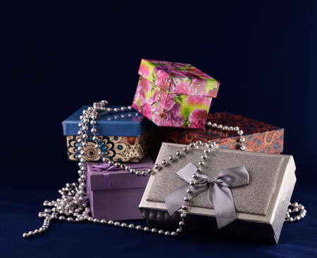 Beautiful and bright gift boxes on a blue background. The concept of the celebration.