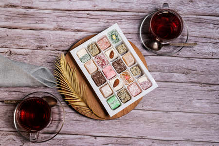 Oriental sweets on a wooden plate and a Cup of tea.