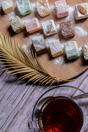 Oriental sweets on a wooden plate and a Cup of tea.の写真素材