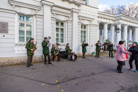October 31, 2020 Saint Petersburg, Russia. People dance in the Central recreation Park to the accompaniment of a military band. Beautiful autumn weather.のeditorial素材
