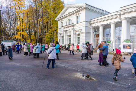 October 31, 2020 Saint Petersburg, Russia. People dance in the Central recreation Park to the accompaniment of a military band. Beautiful autumn weather.のeditorial素材