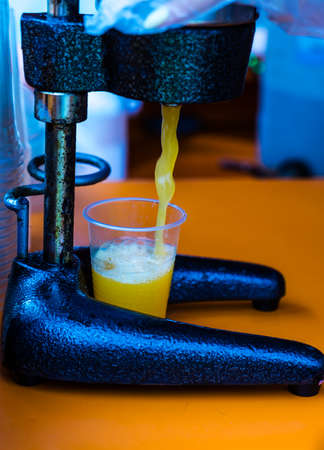 Fresh juice flows into a plastic Cup. The concept of healthy eating.Healthy food and diet.の写真素材