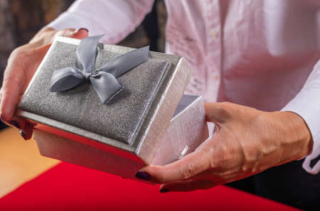 The girl opens the gift. The concept of the new year holiday.の写真素材